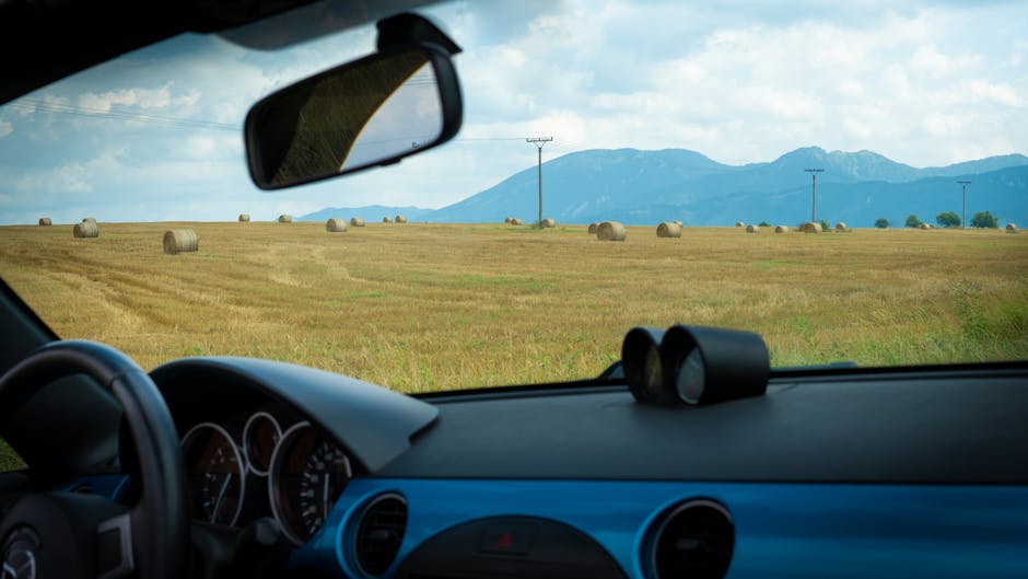 View from car dashboard over fields representing vision and perspective